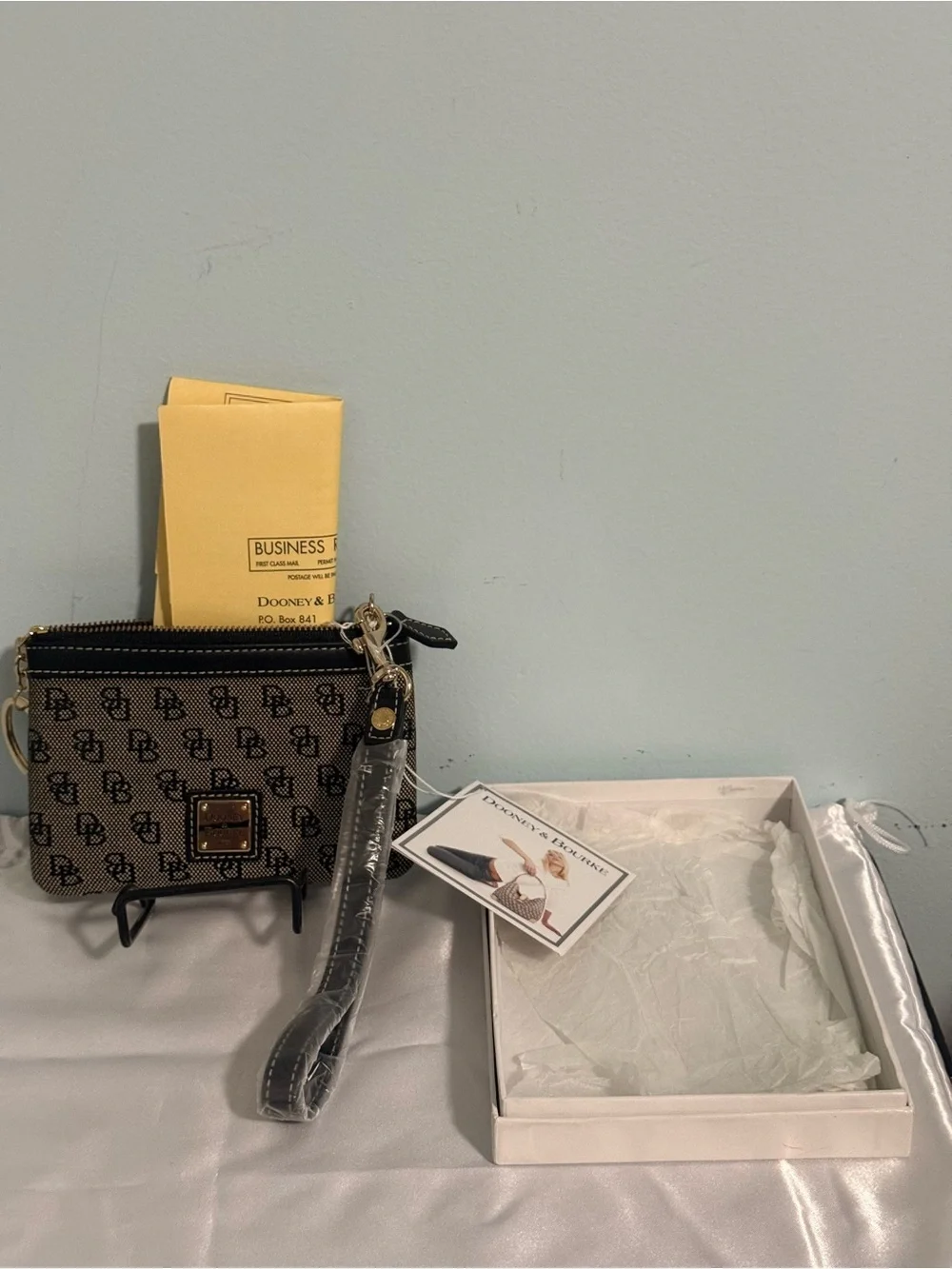Dooney and Bourke NWT Medium logo wristlet. Comes in a box!